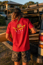 Men's "Salty Locals" Shark T-Shirt - Red | 6725 Broome worn by a man standing next to a vehicle at a coastal site.