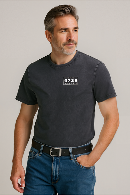 Man wearing stonewashed black t-shirt with 6725 logo