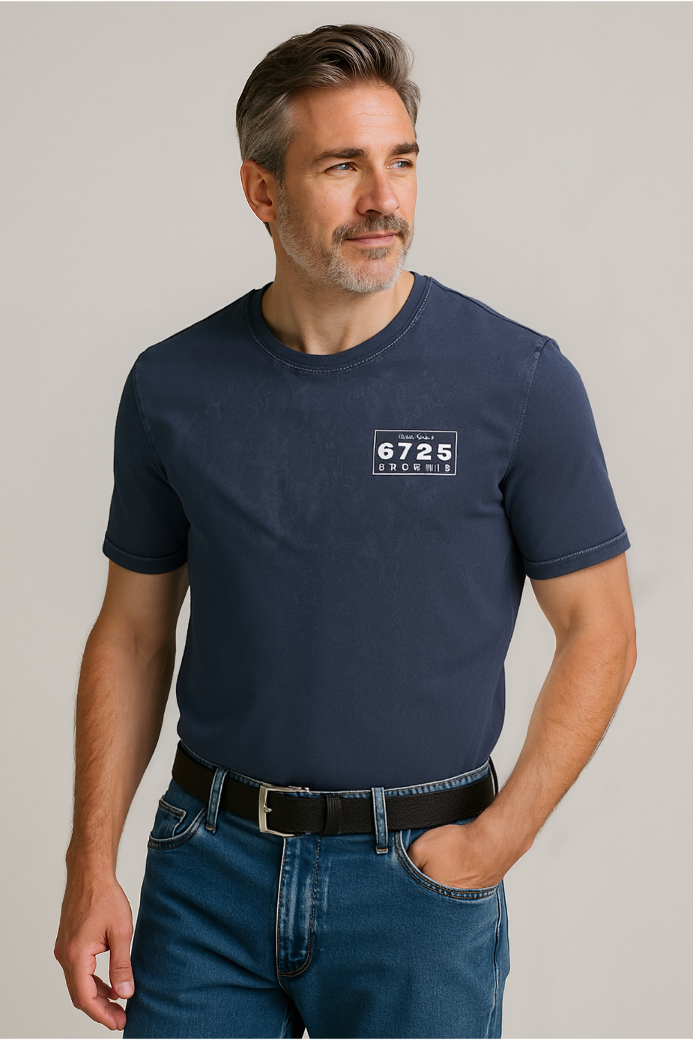 Man wearing a navy blue t-shirt with a logo on a plain background